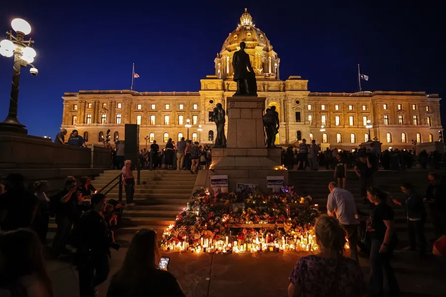 People attend a candlelight vigil outside the state capitol in St Paul, Minnesota